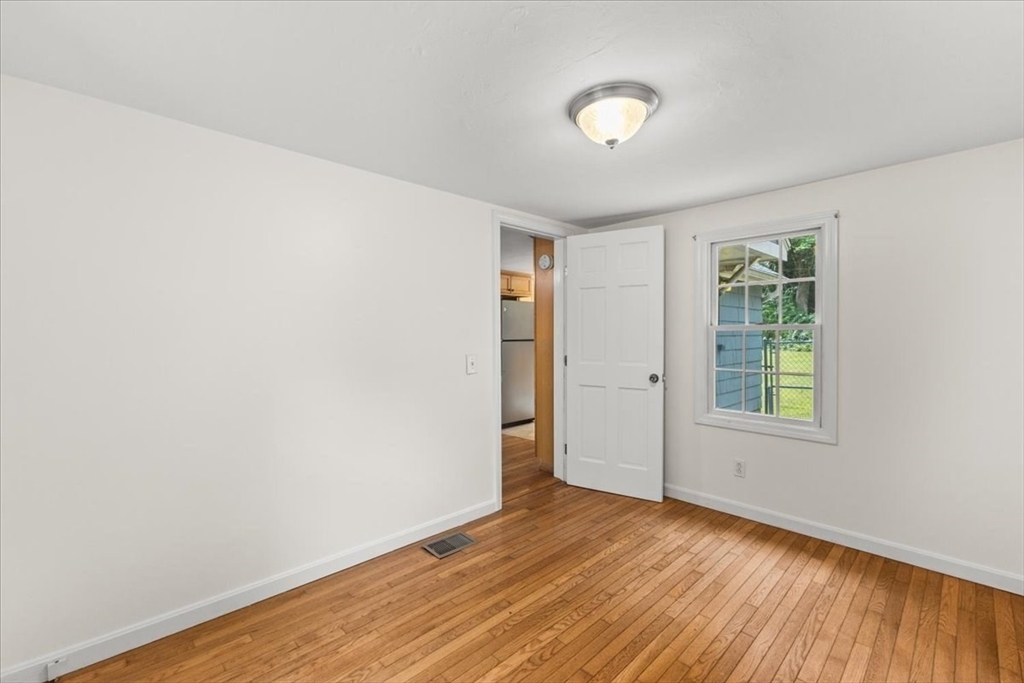 83 River Road Norfolk, MA 02056 - Photo 26 of 27 an empty room with wooden floor and windows