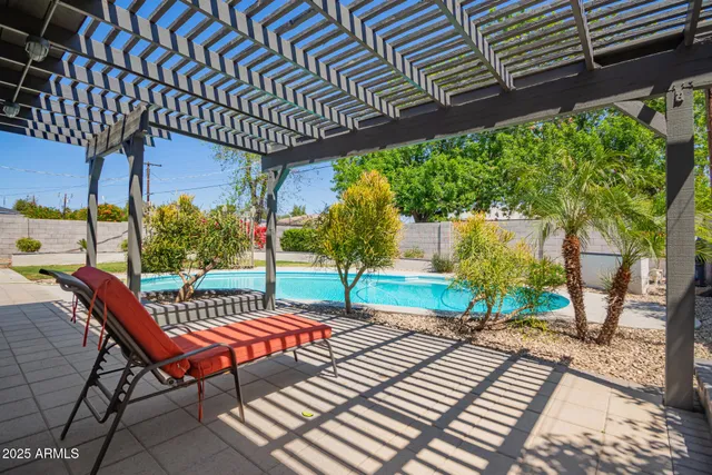 a view of a patio with a table and chairs