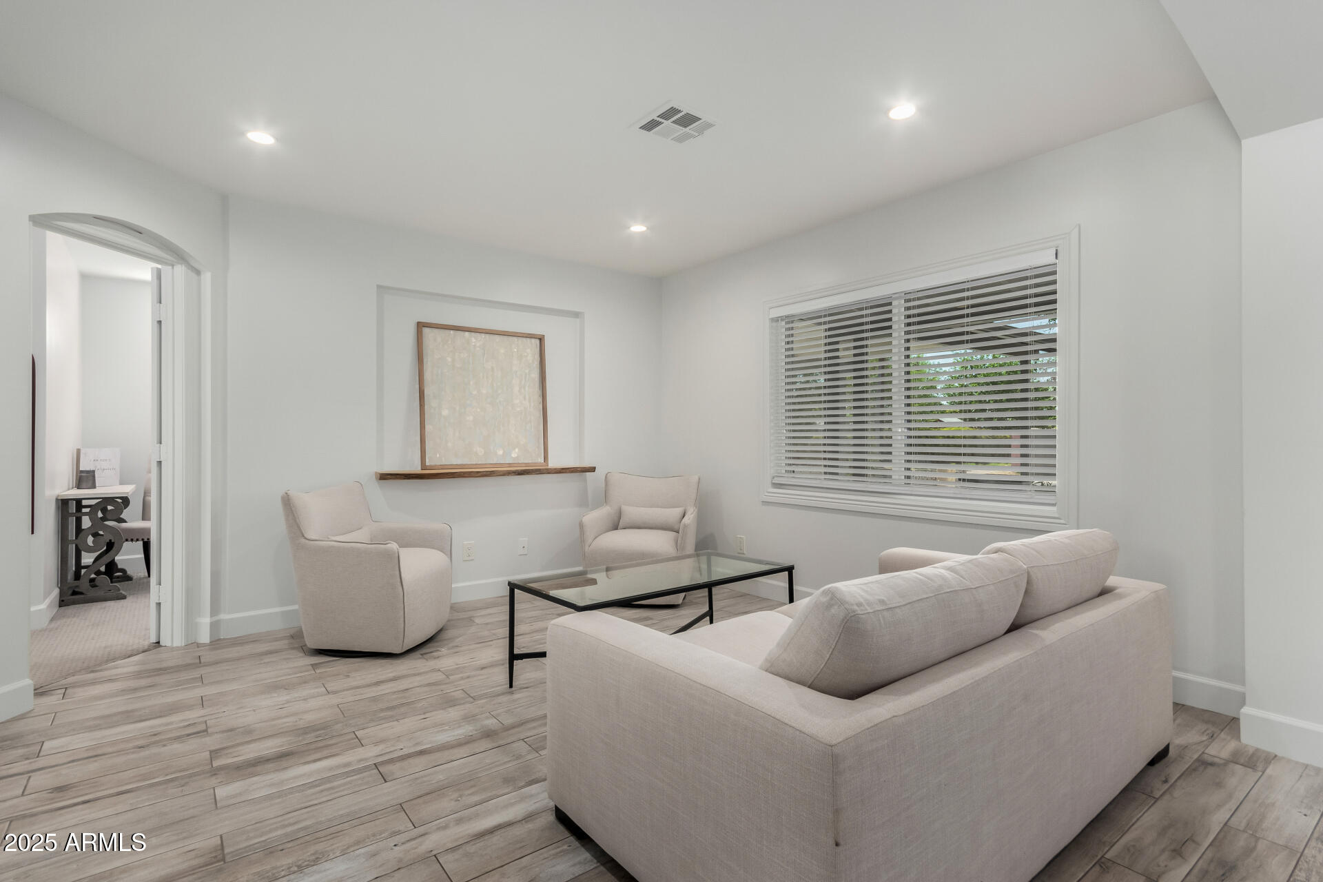 6741 North 10th Street Phoenix, AZ 85014 - Photo 12 of 37 a living room with furniture and a window