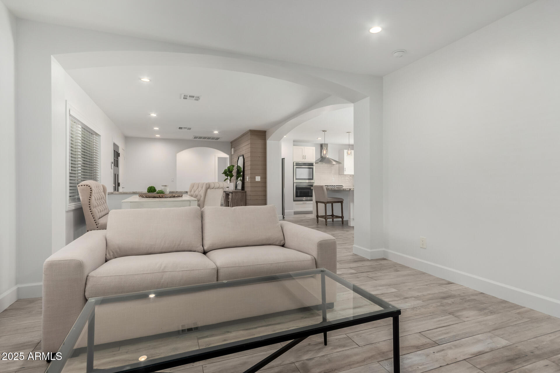 6741 North 10th Street Phoenix, AZ 85014 - Photo 13 of 37 a living room with furniture and a view of kitchen
