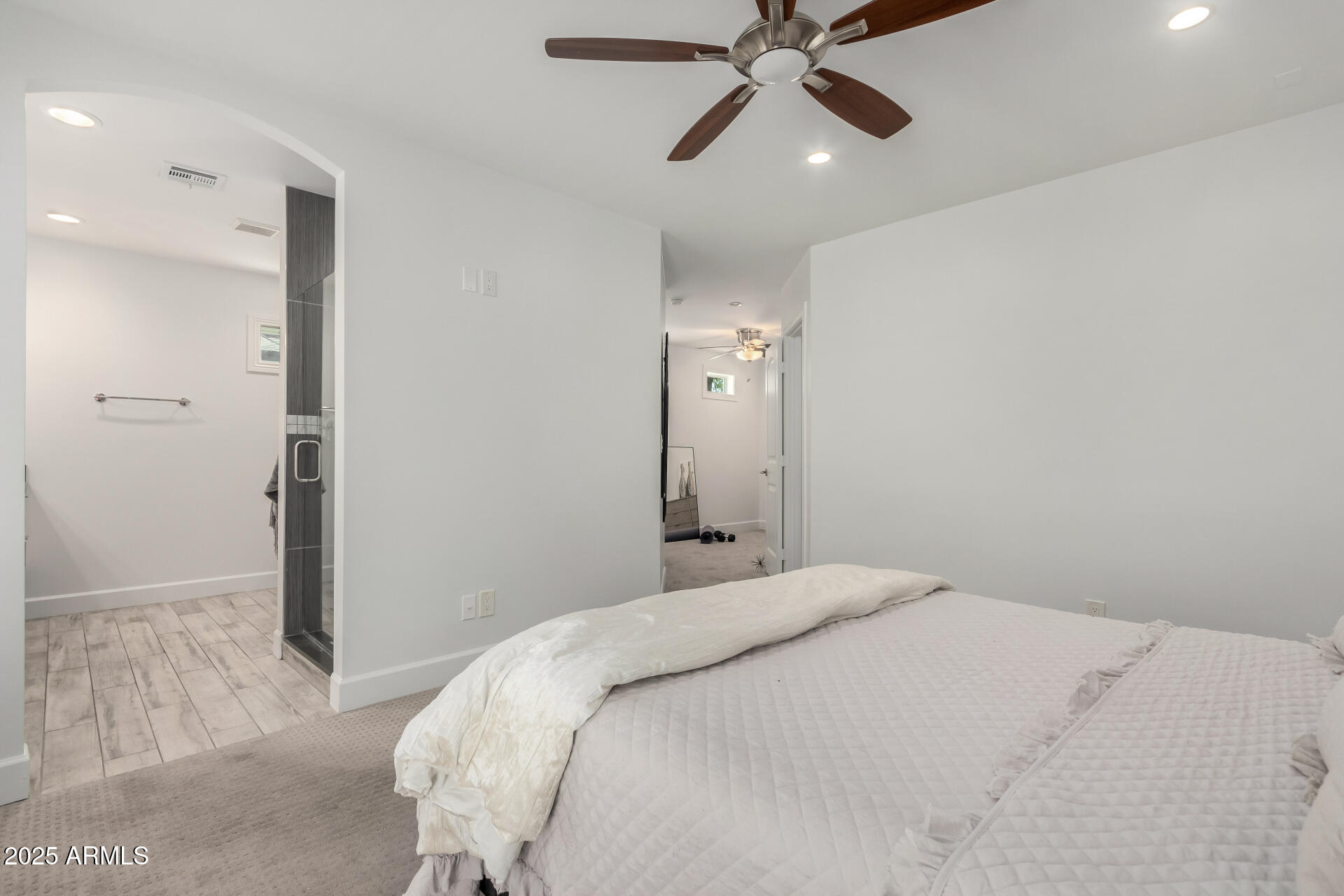 6741 North 10th Street Phoenix, AZ 85014 - Photo 17 of 37 a bedroom with a large bed and a chandelier