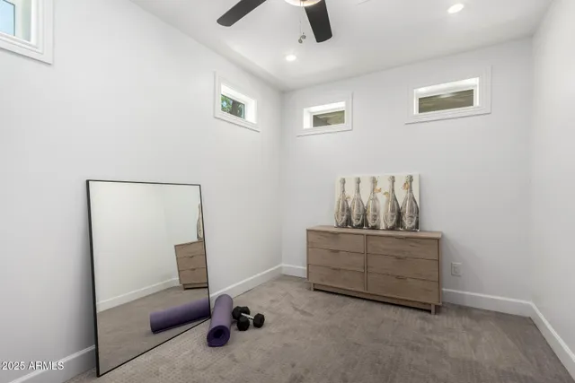 a living room with furniture and a ceiling fan