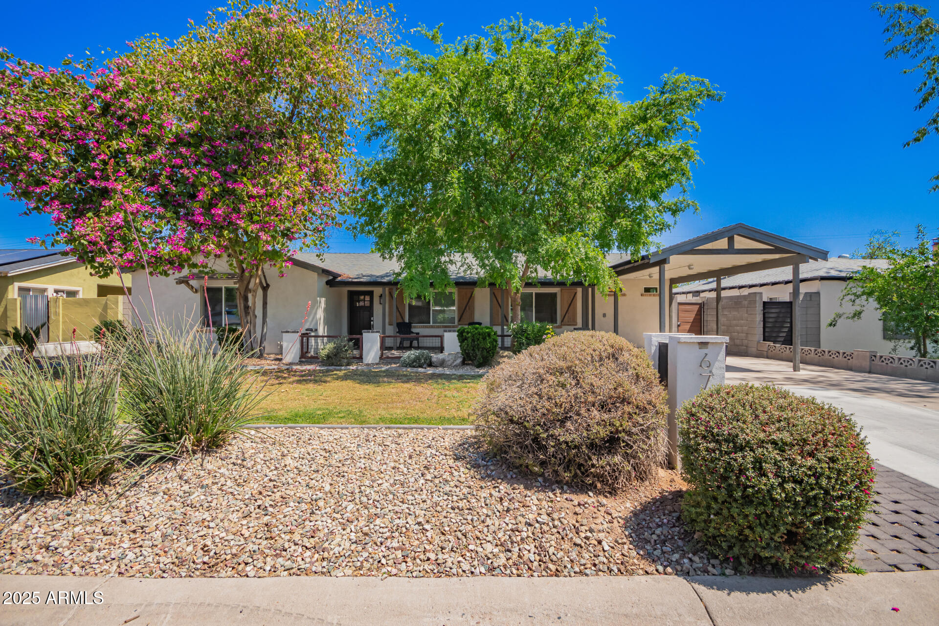 6741 North 10th Street Phoenix, AZ 85014 - Photo 2 of 37 a front view of a house with garden