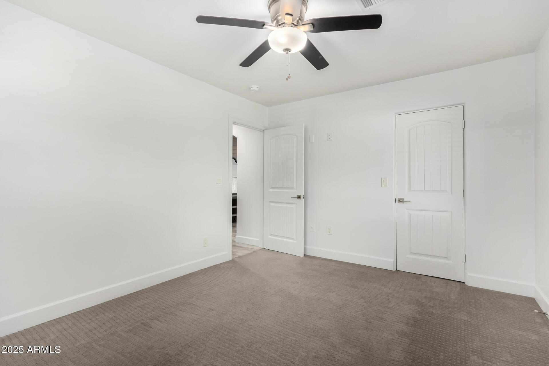 6741 North 10th Street Phoenix, AZ 85014 - Photo 25 of 37 an empty room with closet and a chandelier fan