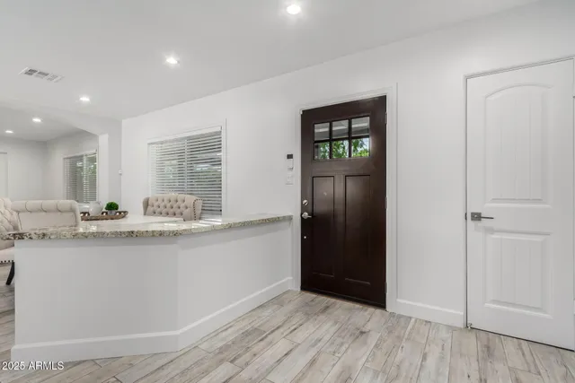 a kitchen with granite countertop a refrigerator and a sink