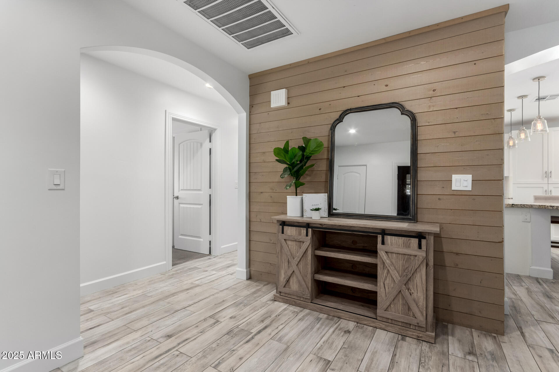6741 North 10th Street Phoenix, AZ 85014 - Photo 5 of 37 a view of a hallway with wooden floor and staircase