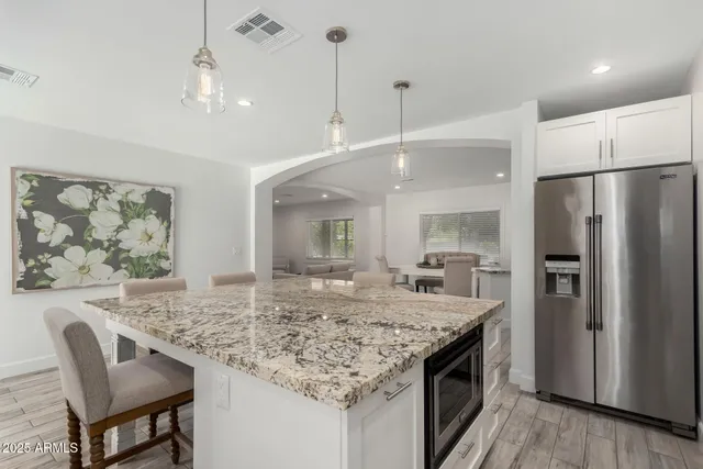 a kitchen with center island and stainless steel appliances