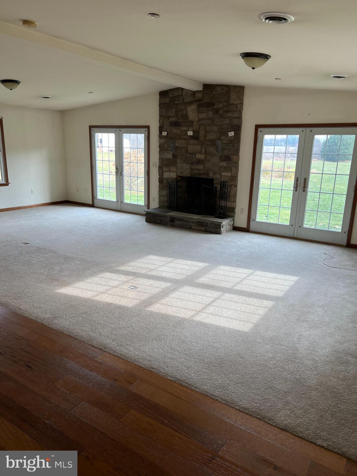 3925 Cap Stine Road Frederick, MD 21703 - Photo 5 of 8 a view of an empty room with a fireplace and a window