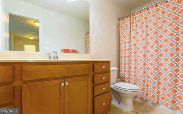 a bathroom with a sink toilet and mirror