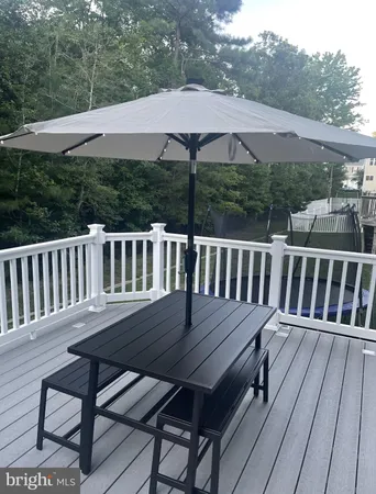 a view of a wooden deck and a backyard