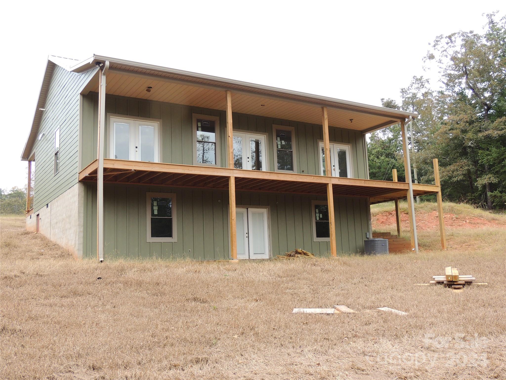 119 Sasafras Ridge Rutherfordton, NC 28139 - Photo 6 of 36 a view of a white house with large windows and a small yard
