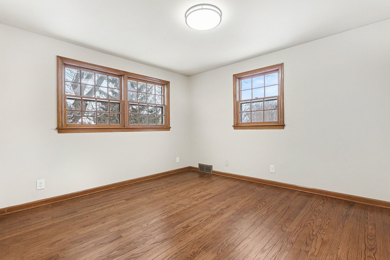 33 South Canterbury Road Aurora, IL 60506 - Photo 16 of 28 an empty room with wooden floor and windows