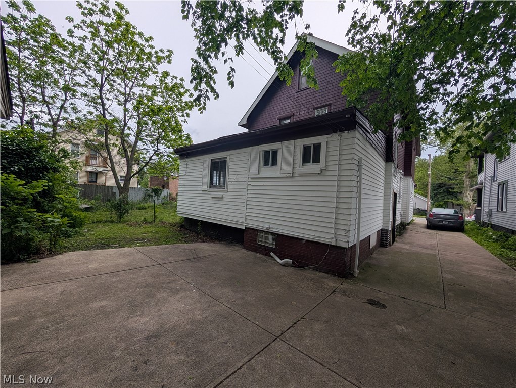 475 East 146th Street Cleveland, OH 44110 - Photo 27 of 28 Concrete driveway extending to the rear of the property