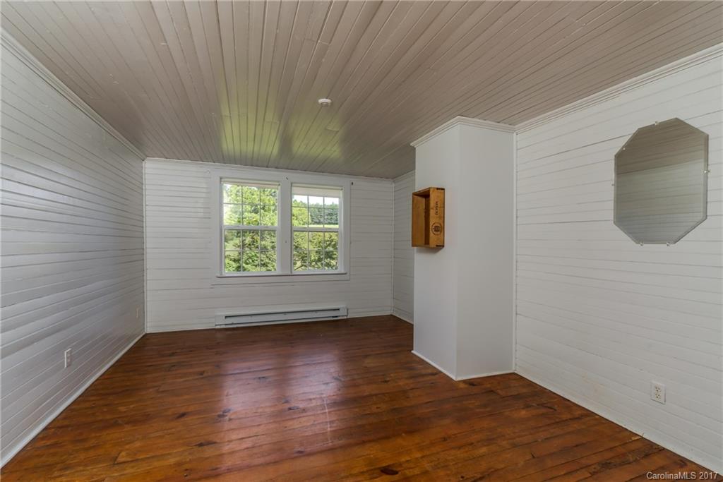 2437 Maple Creek Road Rutherfordton, NC 28139 - Photo 20 of 24 an empty room with wooden floor and windows