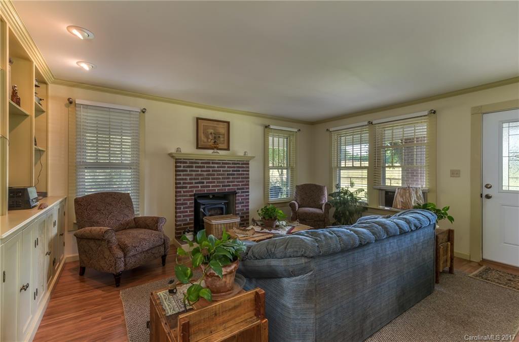 2437 Maple Creek Road Rutherfordton, NC 28139 - Photo 9 of 24 a living room with furniture a large window and a fireplace
