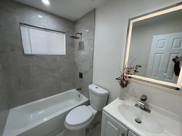 a large kitchen with a sink and a refrigerator
