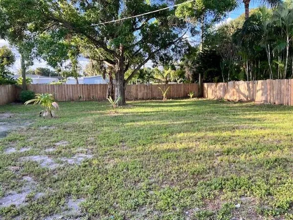a view of a backyard with large trees