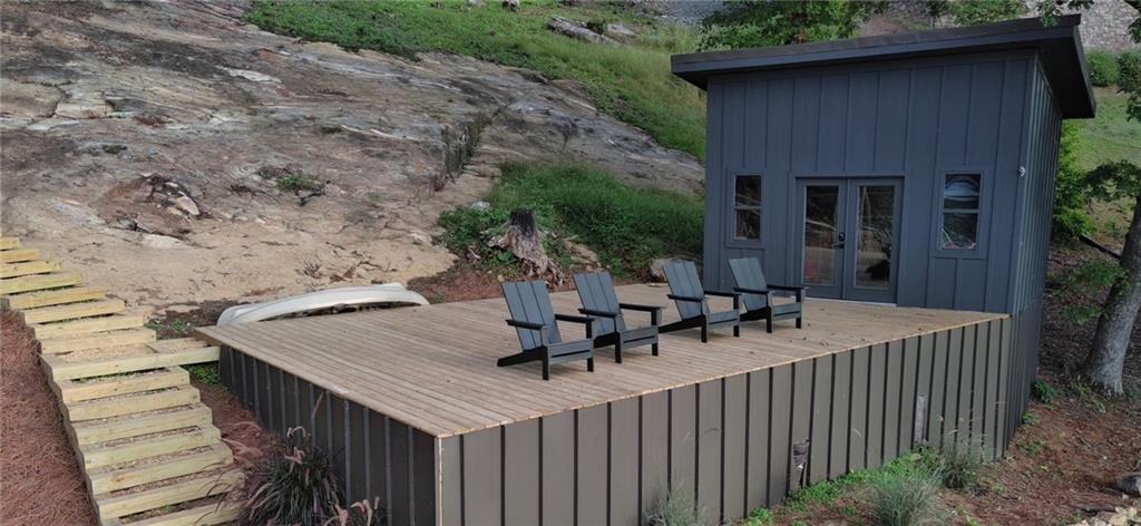 Lot 3 Lake Breeze Acres Other-north Carolina Nc 28904 Hayesville, NC 28904 - Photo 22 of 25 a view of a patio with table and chairs with wooden fence and plants