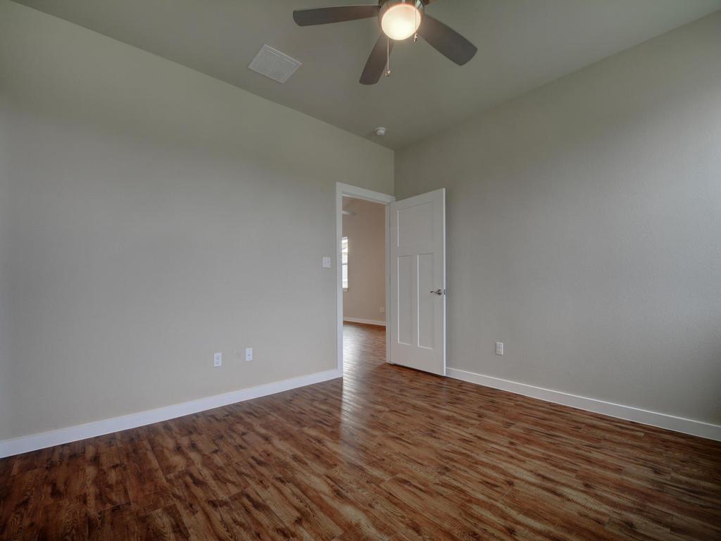 240 Rose Drive, Unit A Dripping Springs, TX 78620 - Photo 13 of 30 a view of an empty room with wooden floor