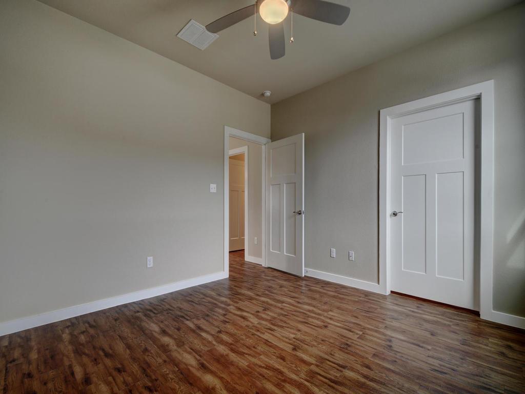 240 Rose Drive, Unit A Dripping Springs, TX 78620 - Photo 20 of 30 wooden floor in an empty room