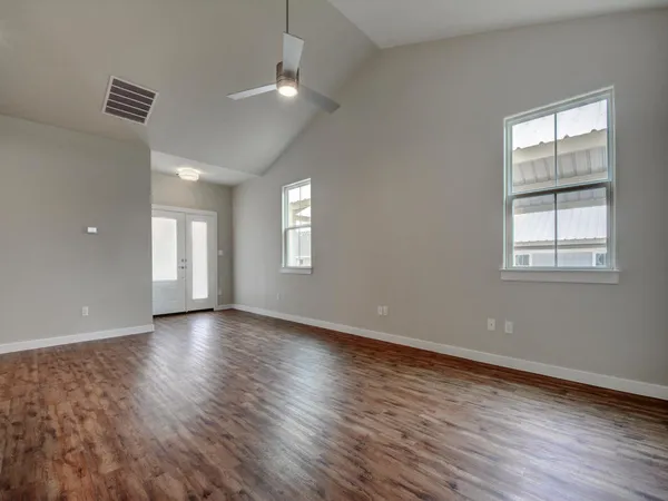 a view of kitchen with kitchen island stainless steel appliances cabinets and wooden floor