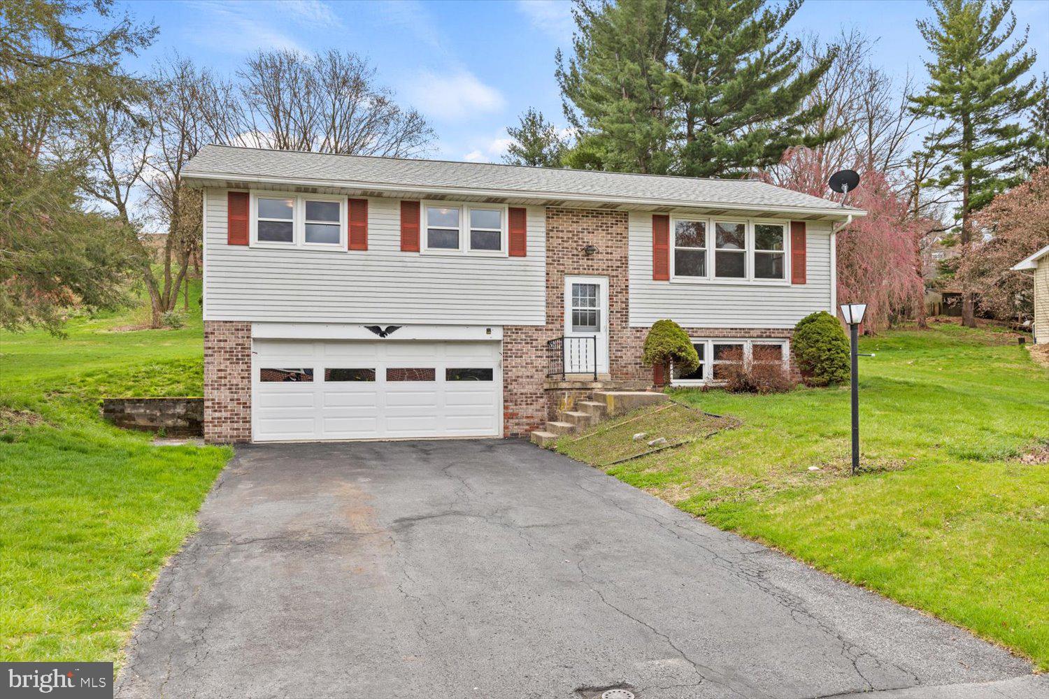 134 Bomberger Road Akron, PA 17501 - Photo 3 of 20 a view of a house with a yard and a tree