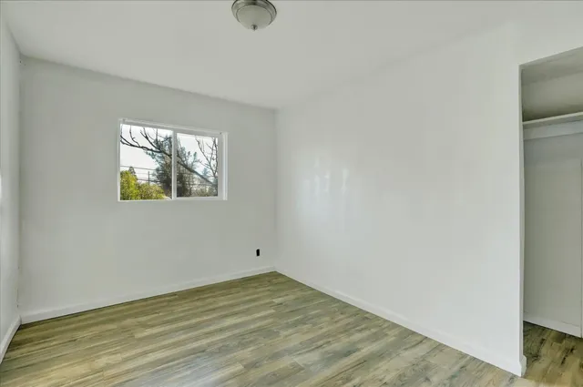 wooden floor in an empty room with a window