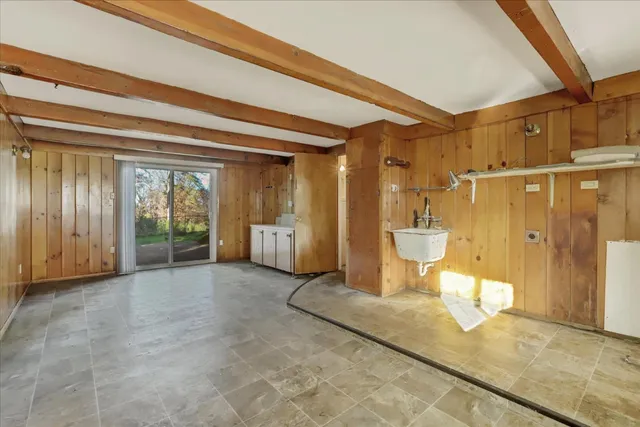 a view of an empty room with windows and a fireplace