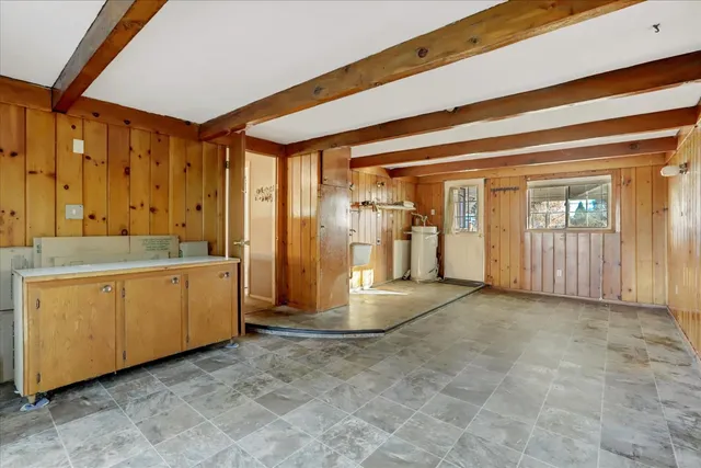 an empty room with a fireplace and a window