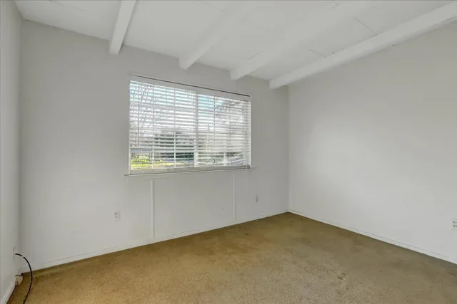 a view of a house with a tree in the background