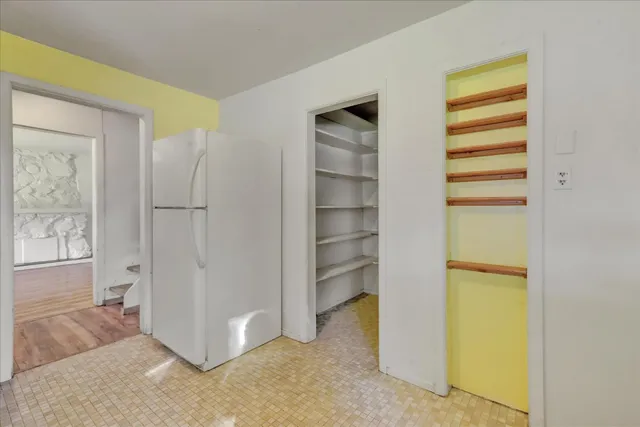 a kitchen with granite countertop white cabinets and stainless steel appliances