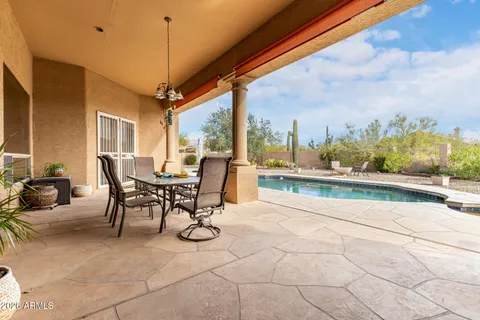 a view of a patio with a table and chairs