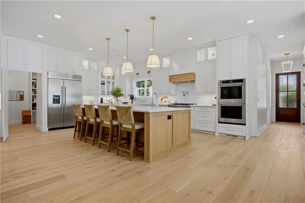 985 Whitehead Road Sugar Hill, GA 30518 - Photo 22 of 85 a large kitchen with a table and chairs
