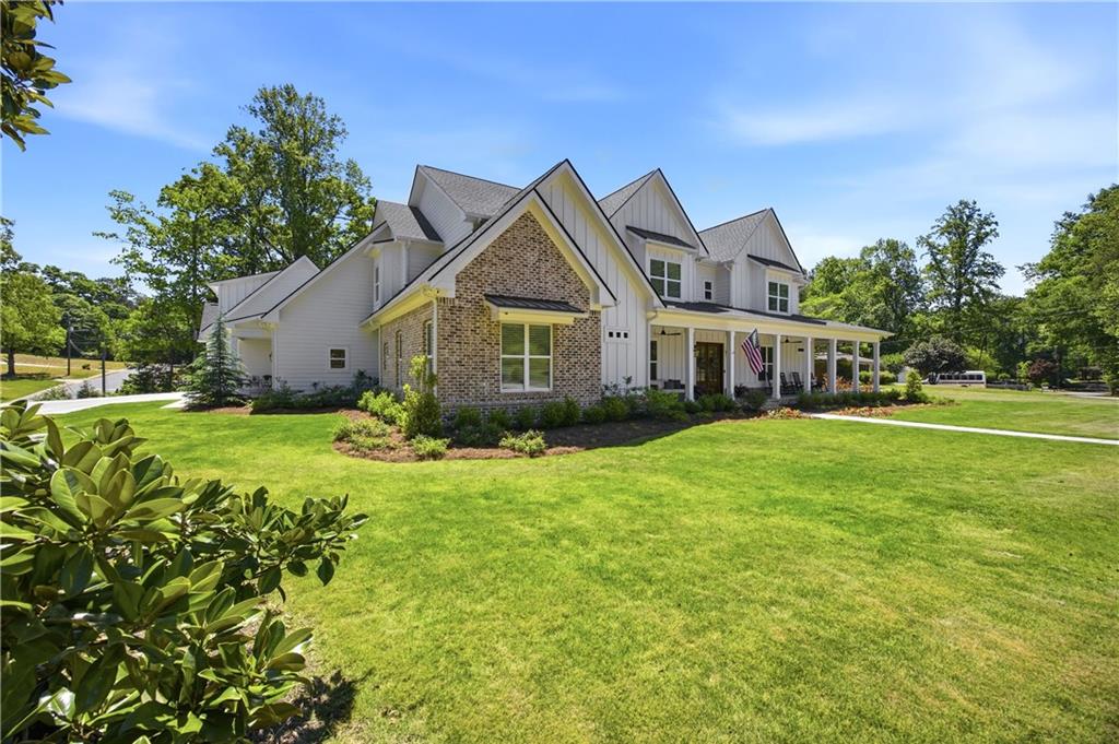 985 Whitehead Road Sugar Hill, GA 30518 - Photo 3 of 85 a front view of a house with a garden