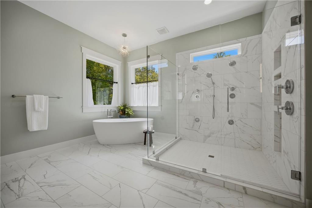985 Whitehead Road Sugar Hill, GA 30518 - Photo 36 of 85 a bathroom with a tub shower and window