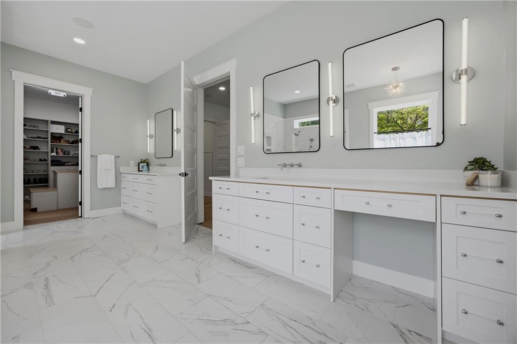 985 Whitehead Road Sugar Hill, GA 30518 - Photo 39 of 85 a spacious bathroom with a granite countertop sink and a mirror