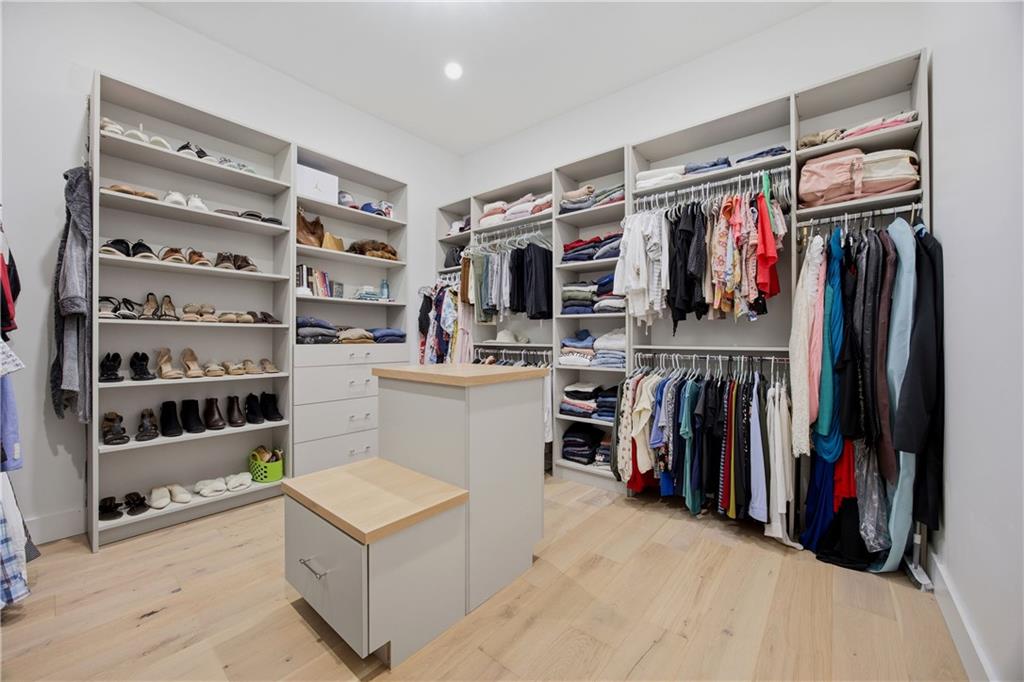 985 Whitehead Road Sugar Hill, GA 30518 - Photo 40 of 85 a view of walk in closet with clothes and shoes