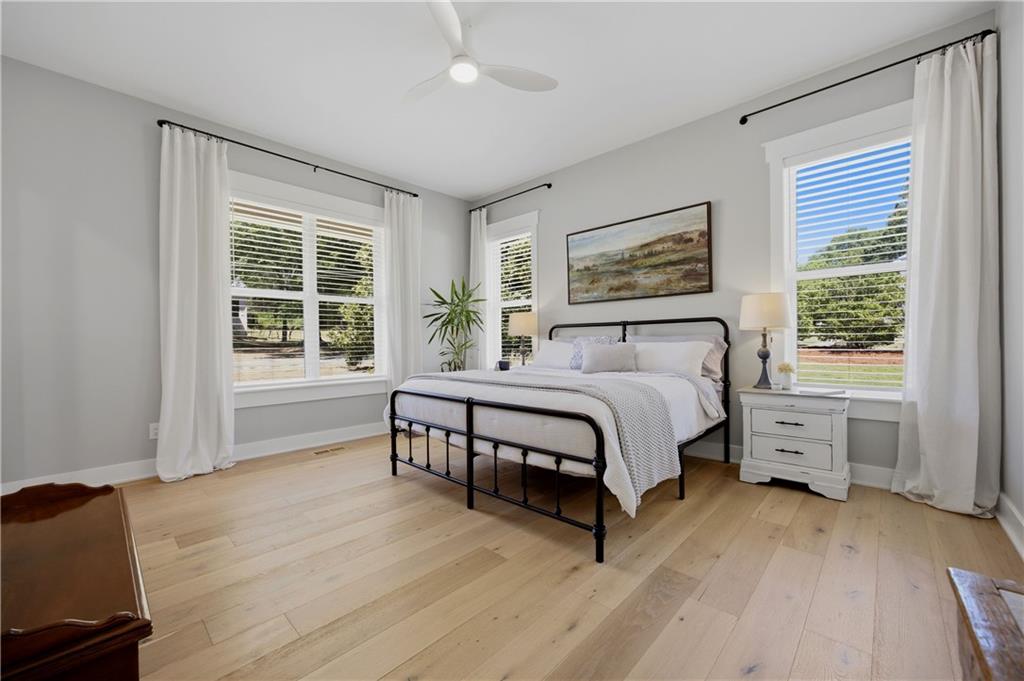 985 Whitehead Road Sugar Hill, GA 30518 - Photo 41 of 85 a spacious bedroom with a large bed and a window