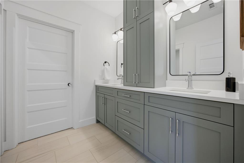 985 Whitehead Road Sugar Hill, GA 30518 - Photo 58 of 85 a bathroom with a double vanity sink and mirror