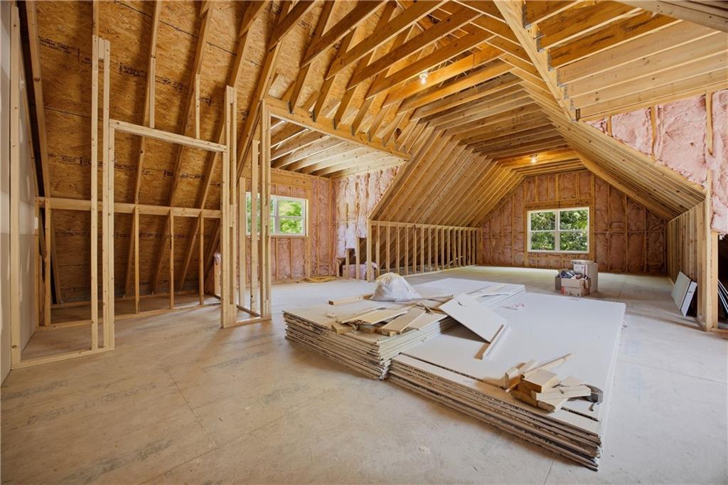 985 Whitehead Road Sugar Hill, GA 30518 - Photo 61 of 85 a spacious bedroom with a bed and a window