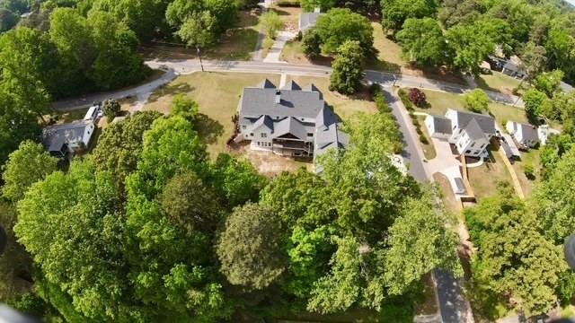 985 Whitehead Road Sugar Hill, GA 30518 - Photo 80 of 85 an aerial view of a house with a yard lake and trees all around