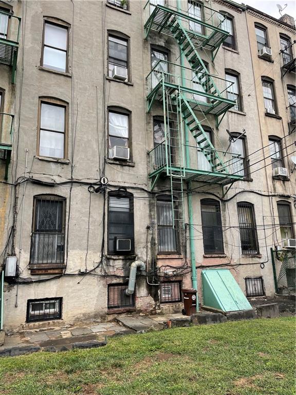 464 60th Street Brooklyn, NY 11220 - Photo 3 of 18 front view of a brick house with a yard