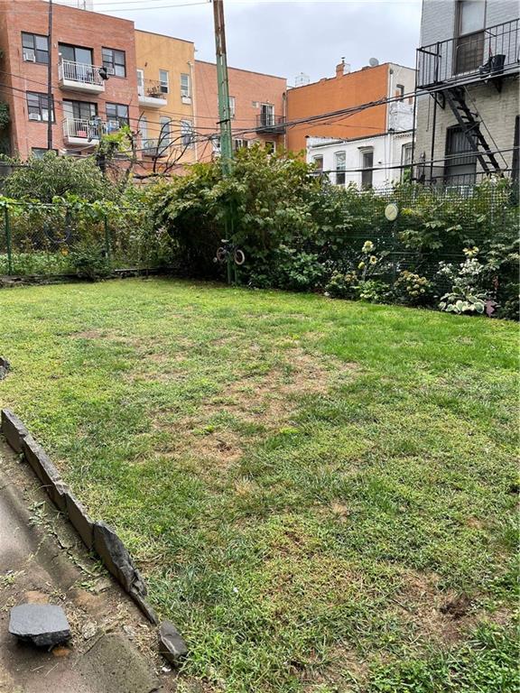 464 60th Street Brooklyn, NY 11220 - Photo 4 of 18 a view of a garden with a building