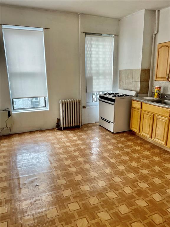 464 60th Street Brooklyn, NY 11220 - Photo 10 of 18 a large kitchen with granite countertop a stove a sink and a granite counter tops