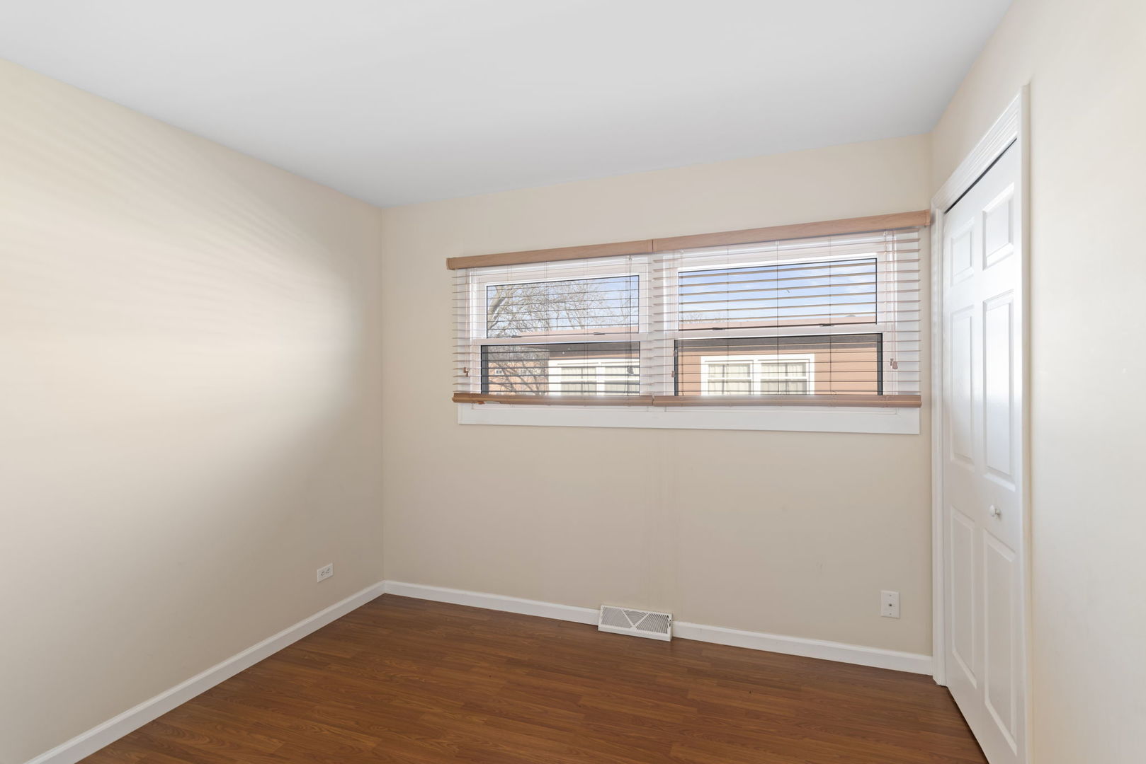 2011 Georgetown Lane Waukegan, IL 60085 - Photo 14 of 16 a view of an empty room with wooden floor and a window