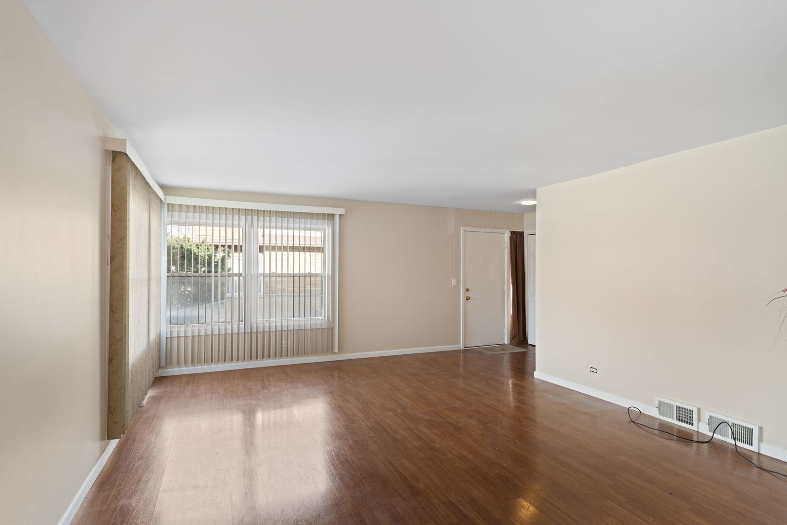 2011 Georgetown Lane Waukegan, IL 60085 - Photo 5 of 16 a view of an empty room with wooden floor and a window