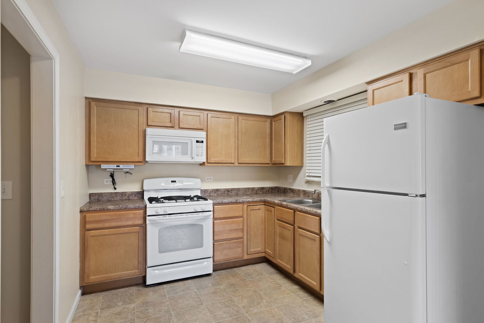 2011 Georgetown Lane Waukegan, IL 60085 - Photo 6 of 16 a white refrigerator freezer sitting inside of a kitchen