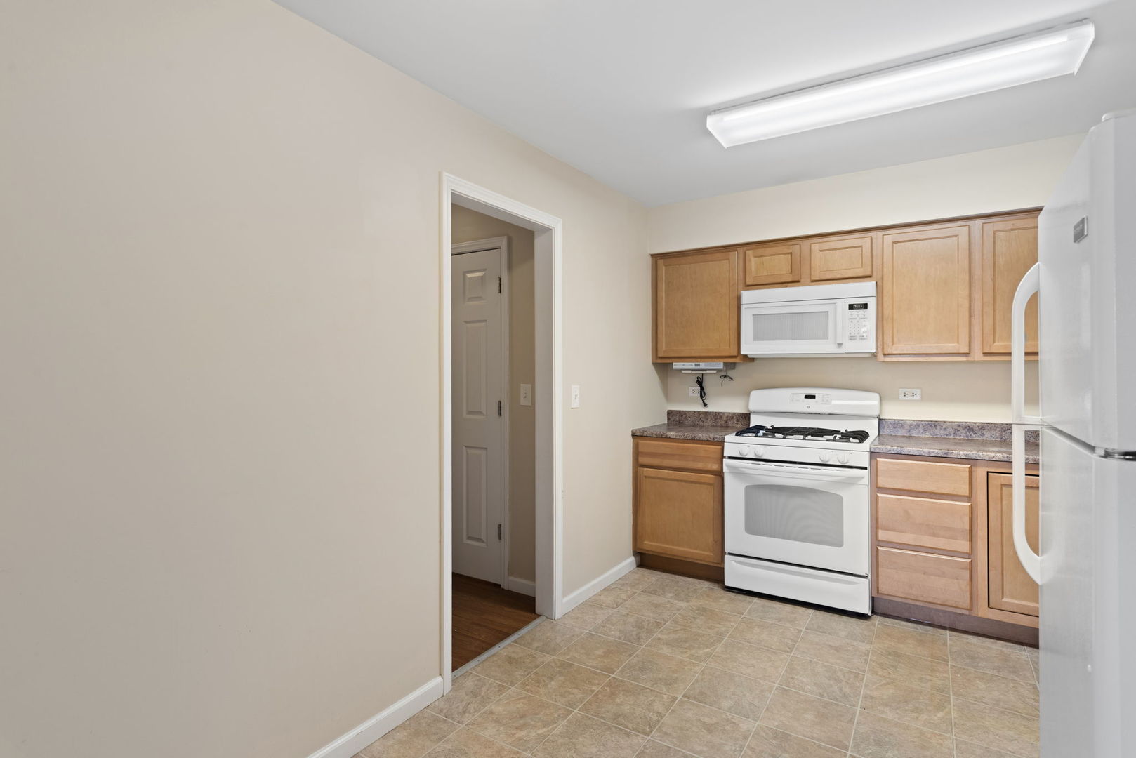 2011 Georgetown Lane Waukegan, IL 60085 - Photo 7 of 16 a kitchen with white cabinets and white appliances