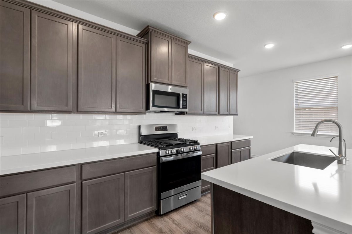 500 Stinchcomb Road Hutto, TX 78634 - Photo 16 of 37 Modern kitchen with white countertops and a contemporary sink for effortless meal preparation.