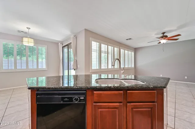 a kitchen with granite countertop a sink and a window